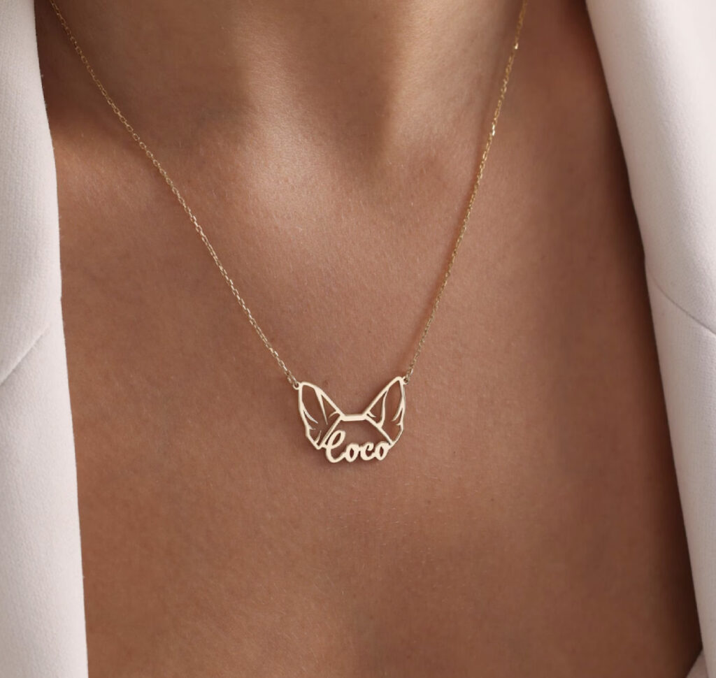 woman wearing necklace of dog ears and name, by TinyTouchCollections on etsy