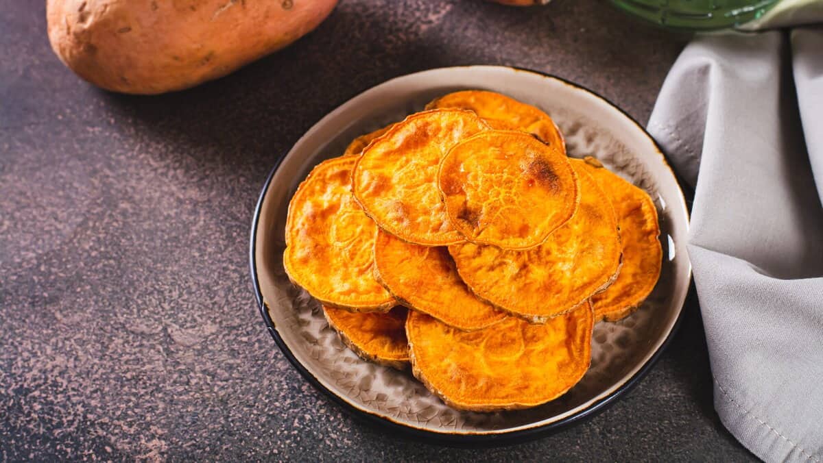 Homemade sliced baked sweet potato on a plate on the table