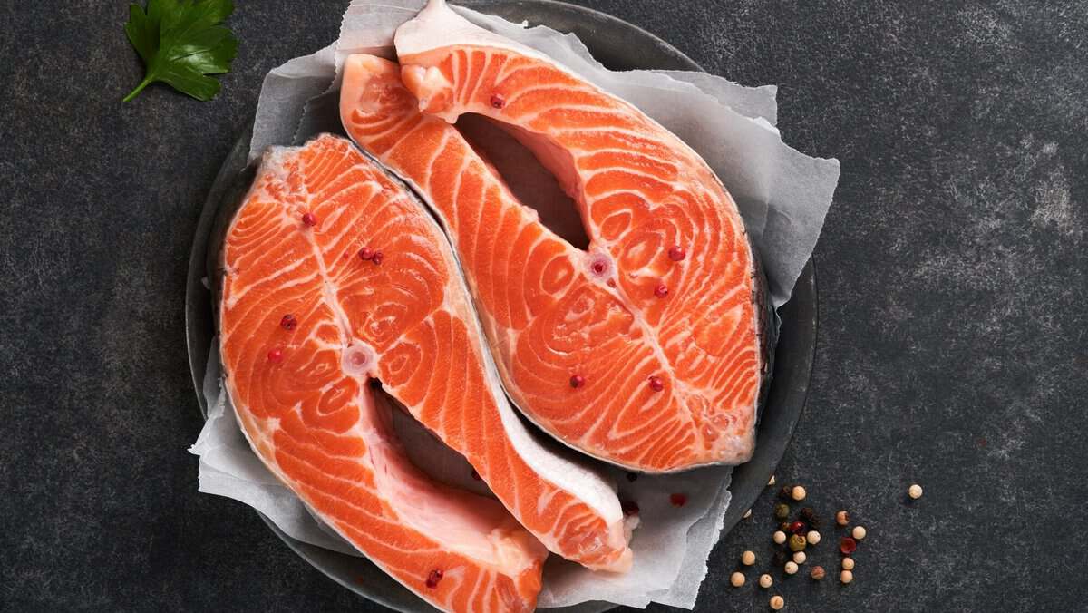 Salmon. Raw salmon steak. Fresh raw salmon fish with cooking ingredients, herbs and lemon prepared f